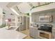 Kitchen with gray cabinets, stainless steel appliances and a decorative garland above the upper cabinets at 108 Fairway Rd, Rotonda West, FL 33947