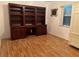 Well-lit office space featuring hardwood floors, dark wooden built-ins and storage, and a large window at 108 Fairway Rd, Rotonda West, FL 33947