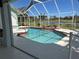 A sparkling screened in-ground pool, perfect for relaxation, overlooking a tranquil canal at 108 Fairway Rd, Rotonda West, FL 33947