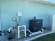 Pool equipment including filter and heater, installed on a concrete pad with light blue siding at 108 Fairway Rd, Rotonda West, FL 33947