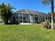 Spacious screened patio overlooking the backyard at 108 Fairway Rd, Rotonda West, FL 33947