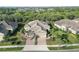 Beautiful aerial view of a lovely home featuring paver driveway and tile roof at 11417 Okaloosa Dr, Venice, FL 34293