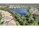 Aerial view of homes surrounding a lake, with lush landscaping and beautiful homes at 11417 Okaloosa Dr, Venice, FL 34293