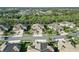 Aerial view of homes in a community with lake views, tile roofs and lush landscaping at 11417 Okaloosa Dr, Venice, FL 34293