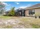 Expansive backyard featuring a screened-in patio, manicured lawn, and mature palm trees at 11417 Okaloosa Dr, Venice, FL 34293