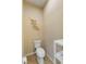 Powder room featuring a modern, decorative wall hanging and an elongated toilet at 11417 Okaloosa Dr, Venice, FL 34293