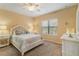 Cozy bedroom with bright walls, ceiling fan, nautical decor, and a white-framed bed at 11417 Okaloosa Dr, Venice, FL 34293