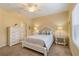Bright bedroom featuring a ceiling fan, nautical decor, a white-framed bed and matching furniture at 11417 Okaloosa Dr, Venice, FL 34293