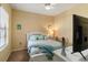 Cozy bedroom with a comfortable bed, ceiling fan, and ample natural light, perfect for relaxation at 11417 Okaloosa Dr, Venice, FL 34293