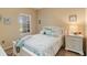 Inviting bedroom features a well-lit window and a charming decor with a comfortable bed at 11417 Okaloosa Dr, Venice, FL 34293