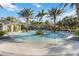 Expansive community pool with shallow beach entry and beautiful landscaping at 11417 Okaloosa Dr, Venice, FL 34293