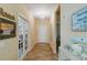Inviting entryway with tile flooring, decorative chandelier, and charming coastal decor throughout at 11417 Okaloosa Dr, Venice, FL 34293