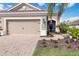 Charming single-story home boasts a well-manicured lawn and a beautiful front yard with vibrant landscaping at 11417 Okaloosa Dr, Venice, FL 34293