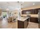 Open concept kitchen with granite counters, stainless steel appliances, and island extending into the living room at 11417 Okaloosa Dr, Venice, FL 34293