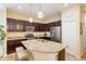 Modern kitchen with stainless steel appliances, granite countertops, and a functional island with seating at 11417 Okaloosa Dr, Venice, FL 34293