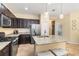 Well-equipped kitchen boasts stainless steel appliances, granite counters, and a central island with barstool seating at 11417 Okaloosa Dr, Venice, FL 34293