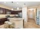 Beautiful kitchen featuring dark cabinets, granite countertops, and a large island with seating for casual dining at 11417 Okaloosa Dr, Venice, FL 34293