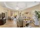 Spacious living room with a ceiling fan, tile flooring, and sliding glass doors at 11417 Okaloosa Dr, Venice, FL 34293