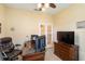 Office features an executive desk, rolling chair, television, and a set of French doors at 11417 Okaloosa Dr, Venice, FL 34293