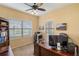 Office featuring a large executive desk, rolling chair, built-in shelving and a bright window at 11417 Okaloosa Dr, Venice, FL 34293