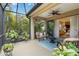 Relaxing screened-in patio with comfortable seating and tropical landscaping views at 11417 Okaloosa Dr, Venice, FL 34293