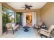 Inviting screened-in patio featuring a fire pit, comfortable seating, and access to the interior at 11417 Okaloosa Dr, Venice, FL 34293