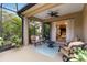 Cozy screened-in patio with comfortable seating, a ceiling fan, and seamless access to the interior at 11417 Okaloosa Dr, Venice, FL 34293