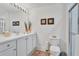 Clean bathroom with white cabinets, framed mirrors, and glass enclosed shower at 13313 Gasparilla Rd # C501 & Slip 11, Placida, FL 33946