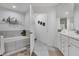 Bright bathroom with a soaking tub, double vanity, and modern fixtures at 13313 Gasparilla Rd # C501 & Slip 11, Placida, FL 33946