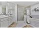 Bright bathroom featuring a soaking tub, enclosed shower, and double vanity at 13313 Gasparilla Rd # C501 & Slip 11, Placida, FL 33946