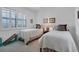 Bright guest bedroom with twin beds, plantation shutters and simple decor at 13313 Gasparilla Rd # C501 & Slip 11, Placida, FL 33946