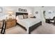 Well-lit bedroom featuring neutral decor, a decorative headboard, carpet, and comfortable bedding at 13313 Gasparilla Rd # C501 & Slip 11, Placida, FL 33946