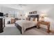 Bedroom with large windows, wood furniture, neutral-toned bedding, and cozy carpeting at 13313 Gasparilla Rd # C501 & Slip 11, Placida, FL 33946