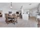 Bright dining and kitchen area features wood floors, elegant dining set, and stainless steel appliances at 13313 Gasparilla Rd # C501 & Slip 11, Placida, FL 33946