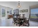 Bright dining room featuring wood furniture, natural light, and balcony access with water views at 13313 Gasparilla Rd # C501 & Slip 11, Placida, FL 33946