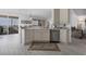 Bright kitchen featuring white cabinets, stainless steel dishwasher, and views of the water from the lanai at 13313 Gasparilla Rd # C501 & Slip 11, Placida, FL 33946