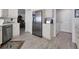 Kitchen area with stainless steel refrigerator and appliances with white cabinets and wood-look floors at 13313 Gasparilla Rd # C501 & Slip 11, Placida, FL 33946
