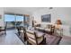 Cozy living area with plush seating, sliding doors to a scenic balcony, and serene water views at 13313 Gasparilla Rd # C501 & Slip 11, Placida, FL 33946