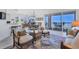Open-concept living space with dining area, balcony access, and scenic water views at 13313 Gasparilla Rd # C501 & Slip 11, Placida, FL 33946