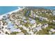 An aerial view of a charming coastal community with a beautiful beach nearby at 14 Palm Dr, Placida, FL 33946