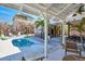 Relaxing backyard oasis featuring a sparkling pool, patio area, outdoor seating, and tropical landscaping at 14 Palm Dr, Placida, FL 33946