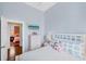 Bright bedroom with wood floors and wicker furniture with connecting access to the next room at 14 Palm Dr, Placida, FL 33946
