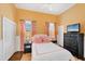Comfortable bedroom featuring bright walls, a ceiling fan, and a large window with custom curtains at 14 Palm Dr, Placida, FL 33946