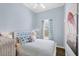 Airy bedroom with blue walls, white furniture, and hardwood floors provides a serene retreat at 14 Palm Dr, Placida, FL 33946