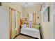 Charming bedroom with colorful curtains, daybed, and cozy decor creates a welcoming space at 14 Palm Dr, Placida, FL 33946