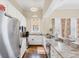 Bright kitchen with stainless steel appliances, stone countertops, and modern white cabinets at 14 Palm Dr, Placida, FL 33946