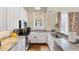 Well-lit kitchen boasting stone countertops, stainless steel appliances, and sleek white cabinetry at 14 Palm Dr, Placida, FL 33946