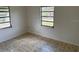 Cozy bedroom with tiled flooring, two large windows, and neutral wall paint at 1417 Terry Ave, Punta Gorda, FL 33980