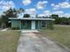 Charming single-story home featuring a long driveway and a well-manicured front lawn at 1417 Terry Ave, Punta Gorda, FL 33980
