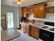 Functional kitchen with wooden cabinets, neutral countertops, and modern appliances at 1417 Terry Ave, Punta Gorda, FL 33980